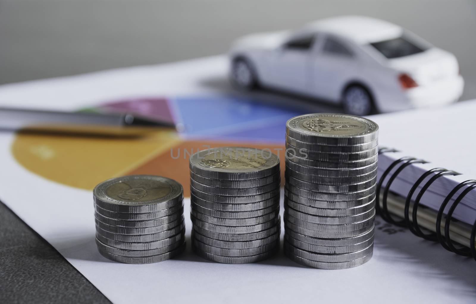 Car insurance and car service with stack of coins. Toy car for accounting and financial concept.
