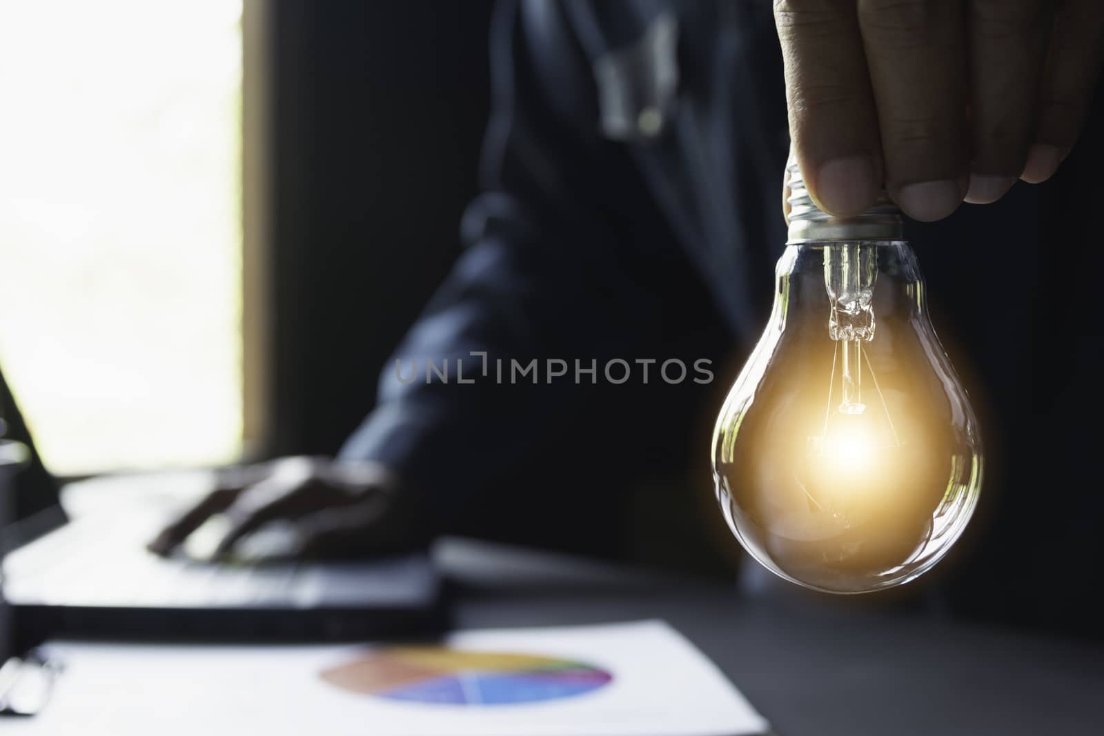 Hand of male holding a light bulb and copy space for accounting, ideas and creative concept.