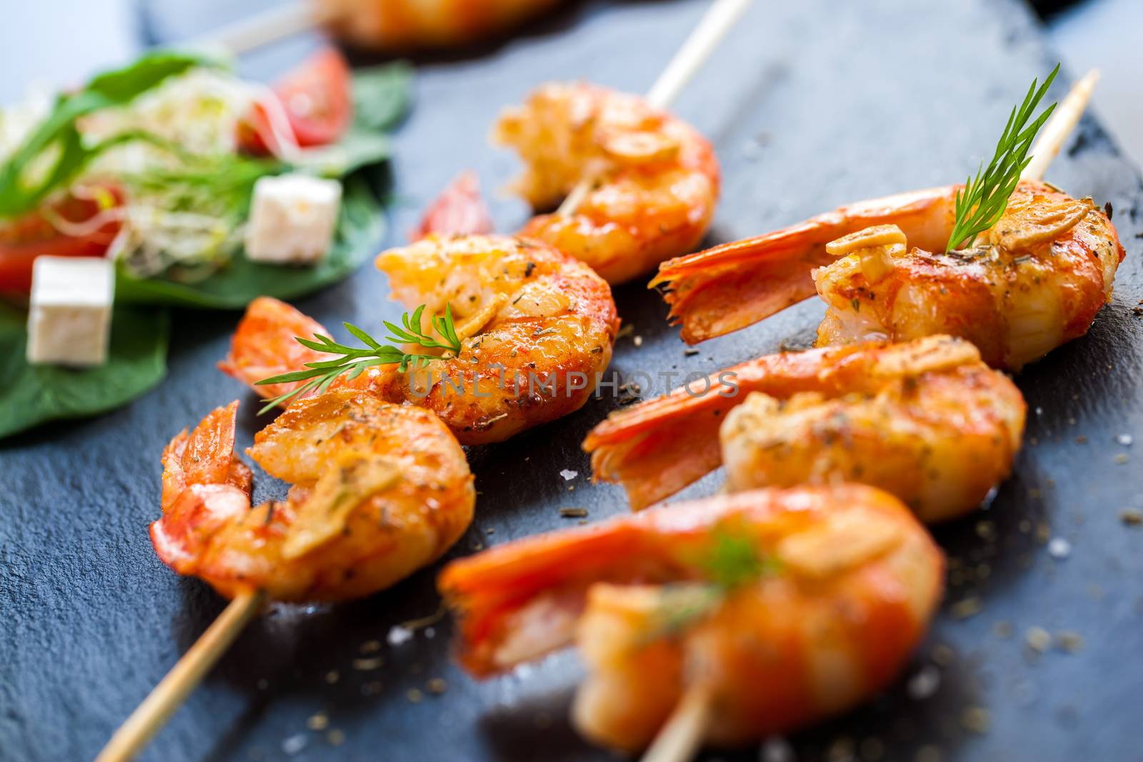 Macro close up of hot spicy char grilled queen prawn brochettes.