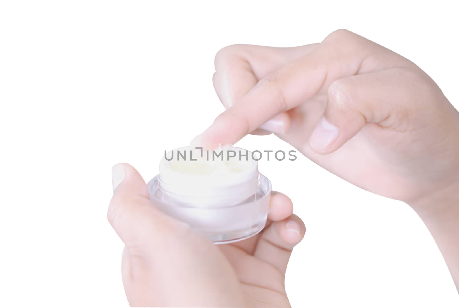Closeup woman hand applying cream or moisturizer from box isolated on white background, selective focus