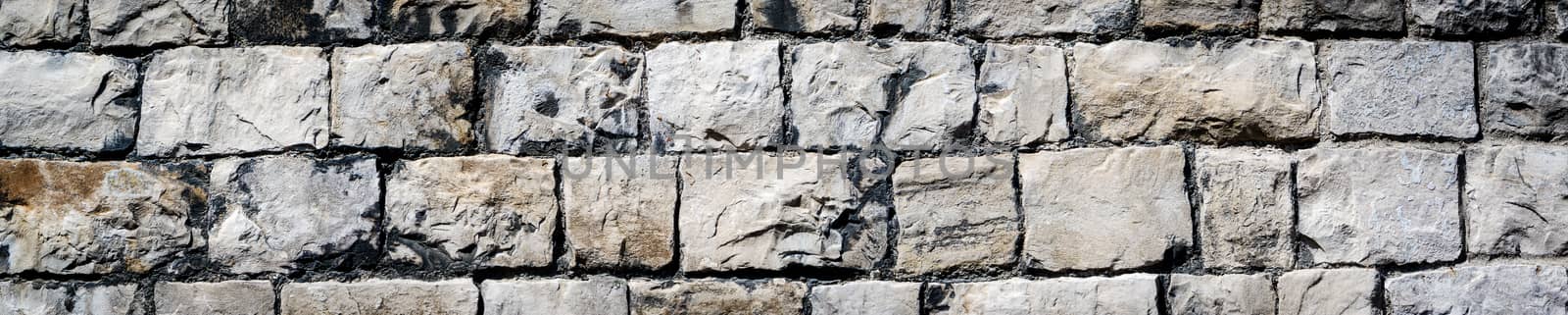panorama of a cracked real stone wall surface Kendal