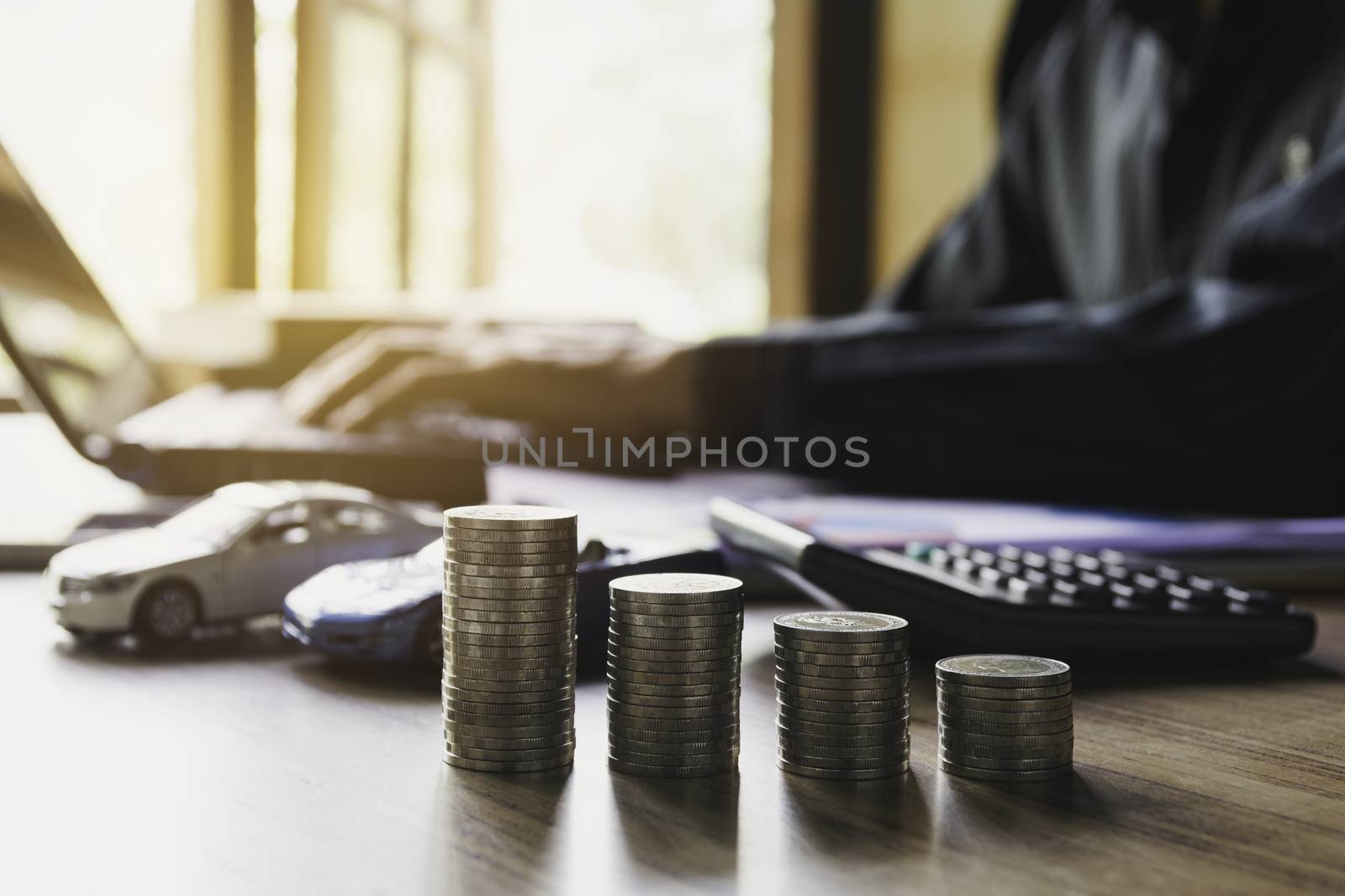 Car insurance and car service with stack of coins. Toy car for accounting and financial concept.