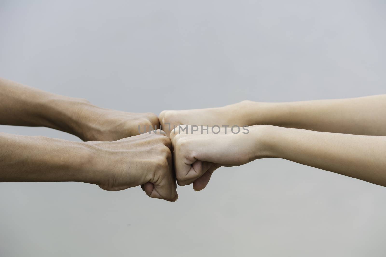 Friend fist bump together at outdoor. Fist bump between colleagues. Friendship and teamwork concept.