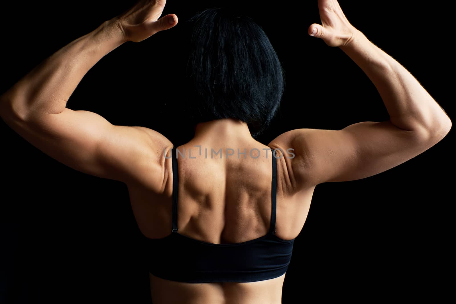 young athletic girl with black hair turned her back and showing  by ndanko