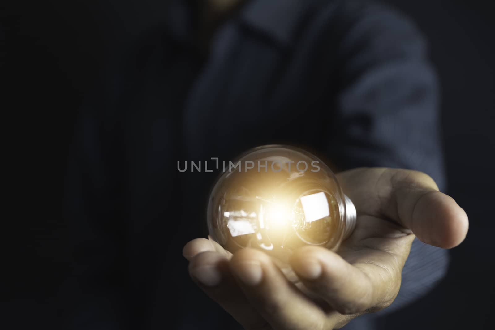 Innovation or creative concept of hand hold a light bulb and copy space for insert text.