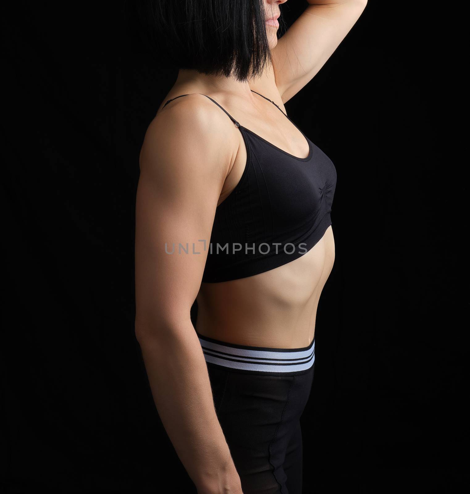 body of a girl of athletic appearance in a black bra and legging by ndanko