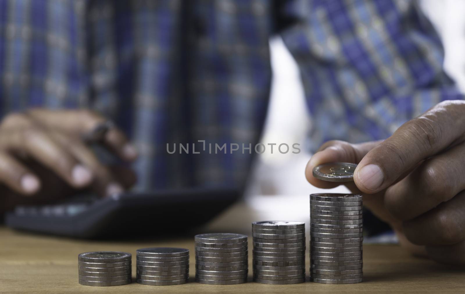 Hand drop a coin with money coin stack growing for business. financial and accounting concept.