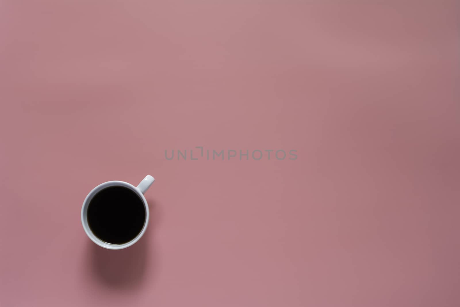 Top view of coffee on pink background and copy space for insert text.