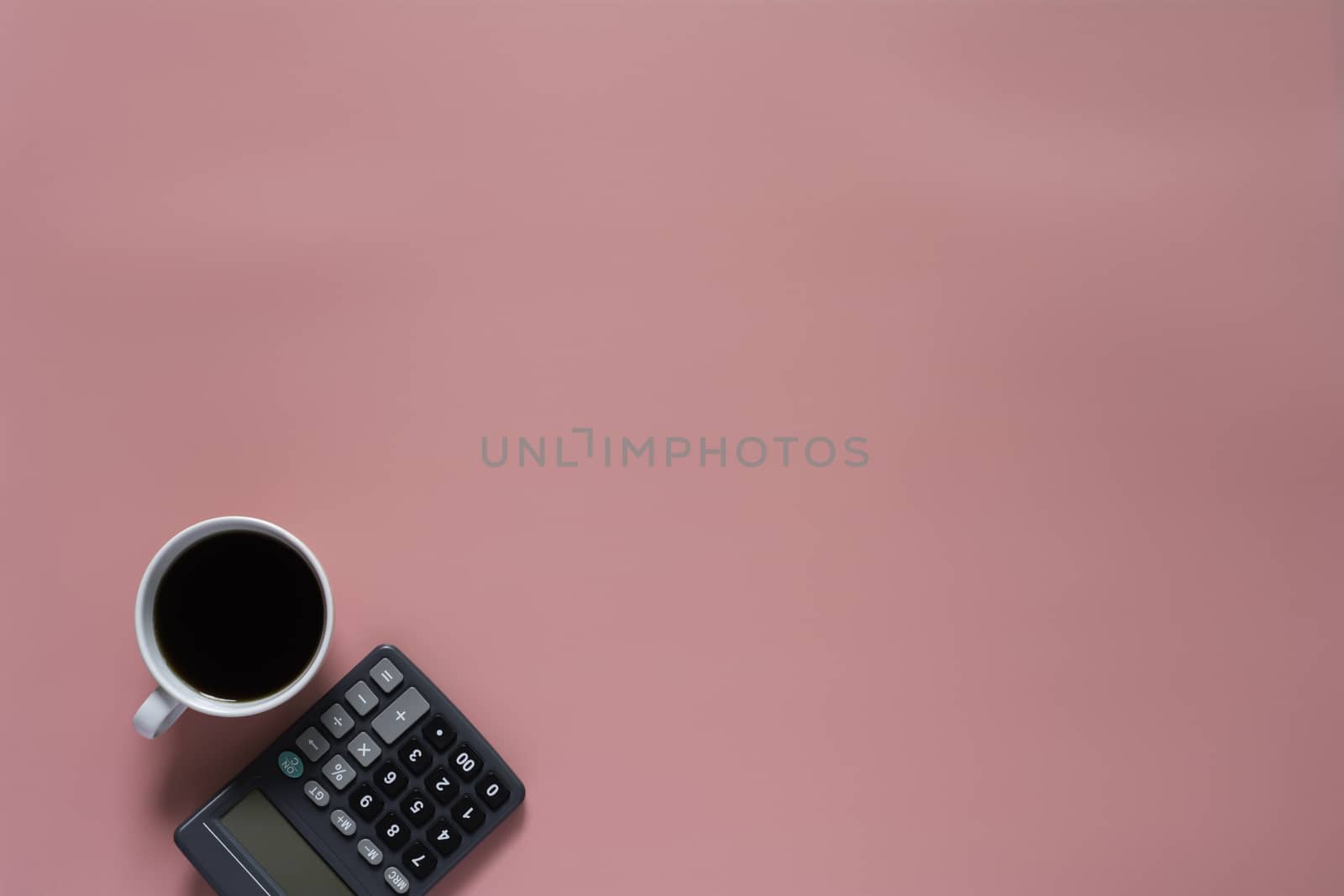 Top view of coffee with calculator on pink background and copy space for insert text.