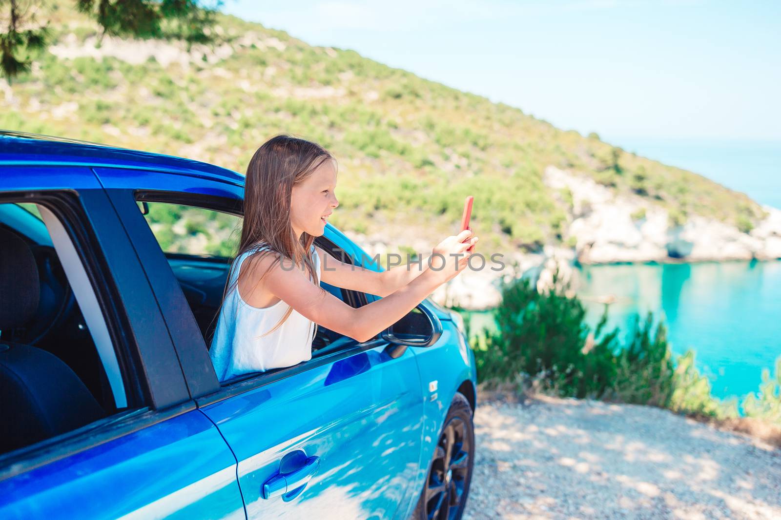 Little girl on vacation travel by car. Summer holiday and car travel concept by travnikovstudio