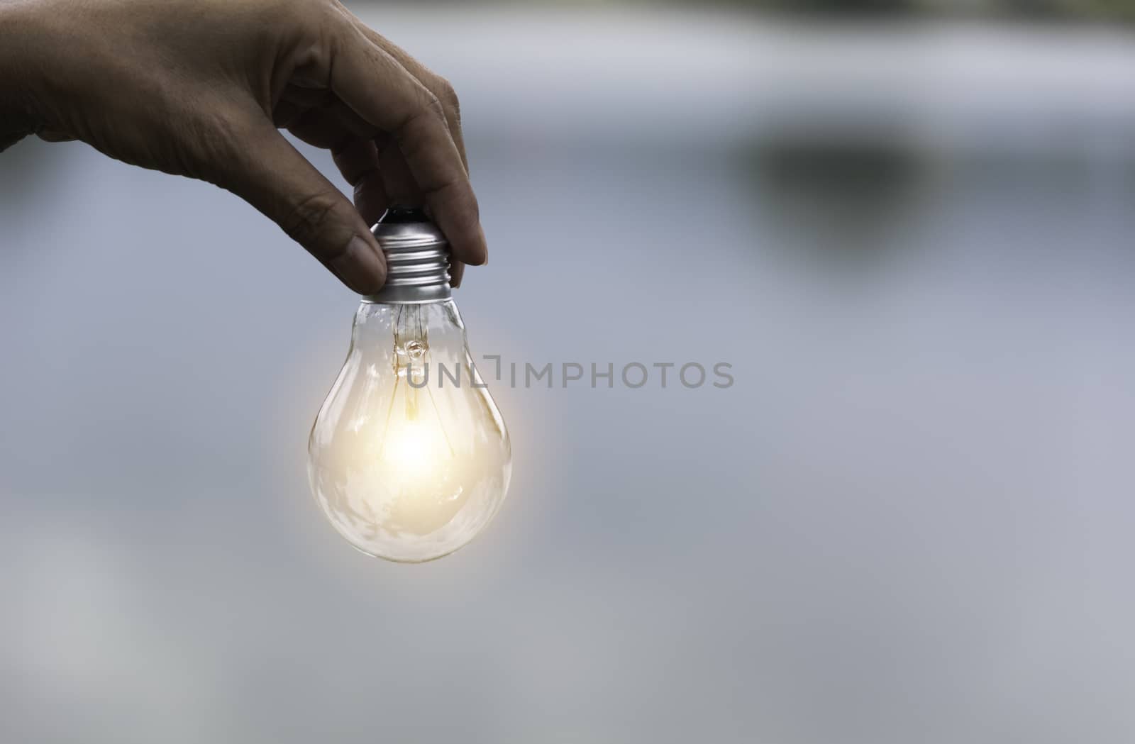 Innovation and creative concept of hand hold a light bulb and copy space for insert text.