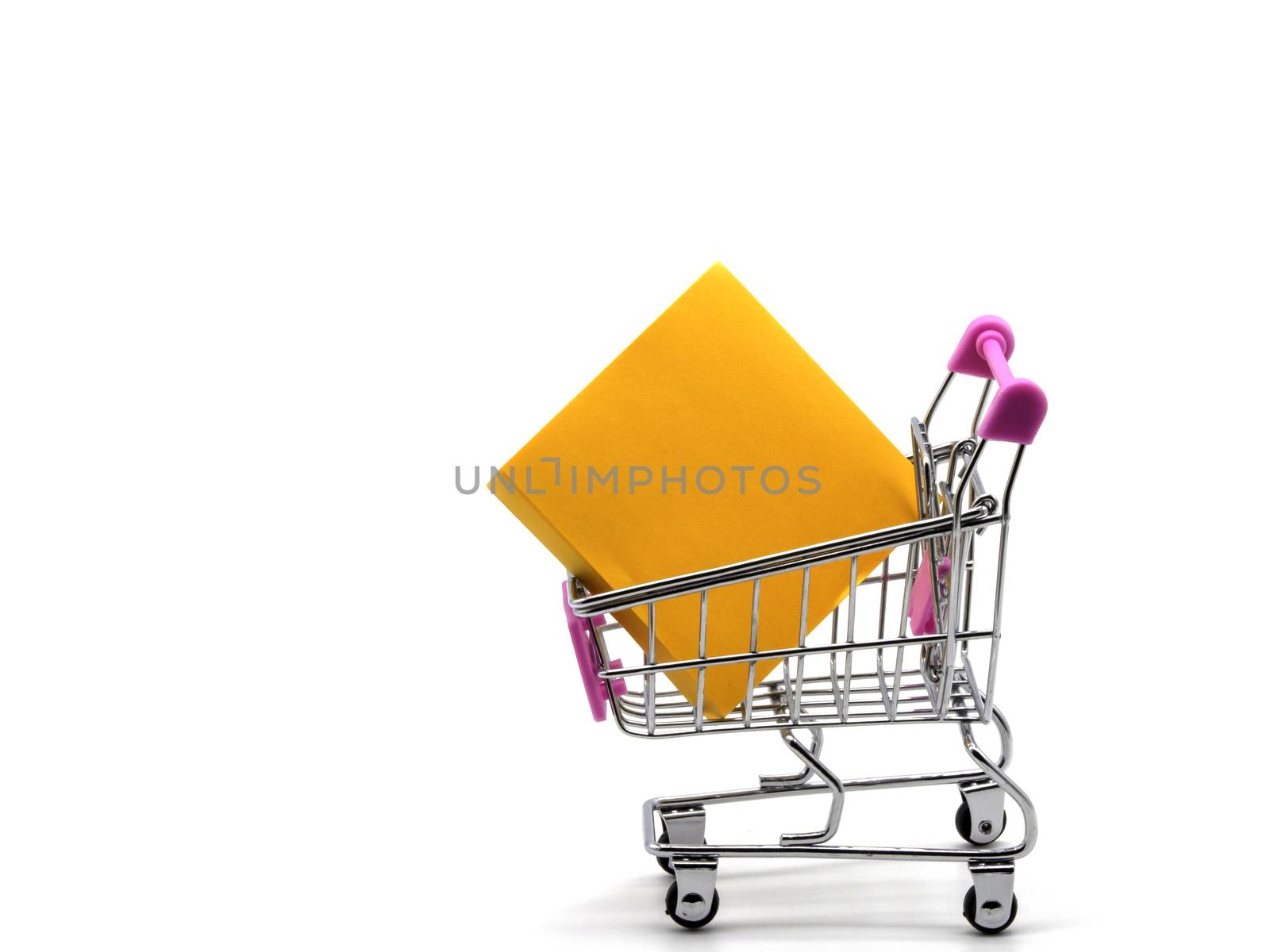 Sticky note and shopping cart isolated and white background.