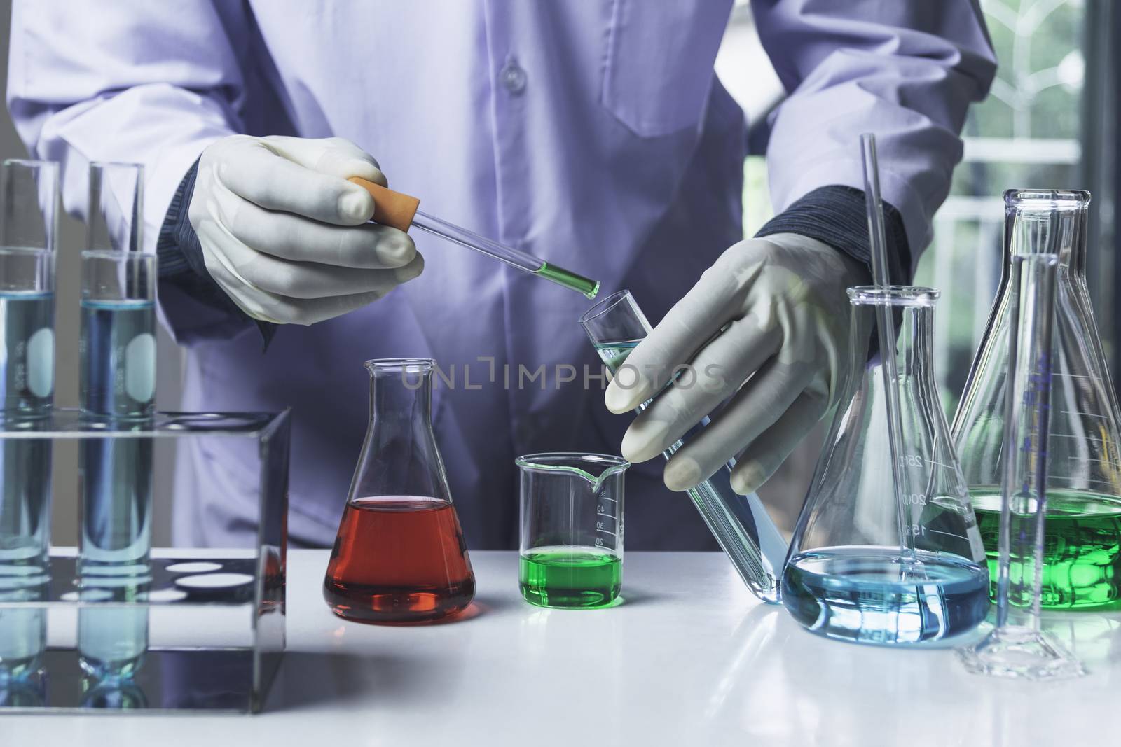 Researcher with glass laboratory chemical test tubes with liquid for analytical , medical, pharmaceutical and scientific research concept.