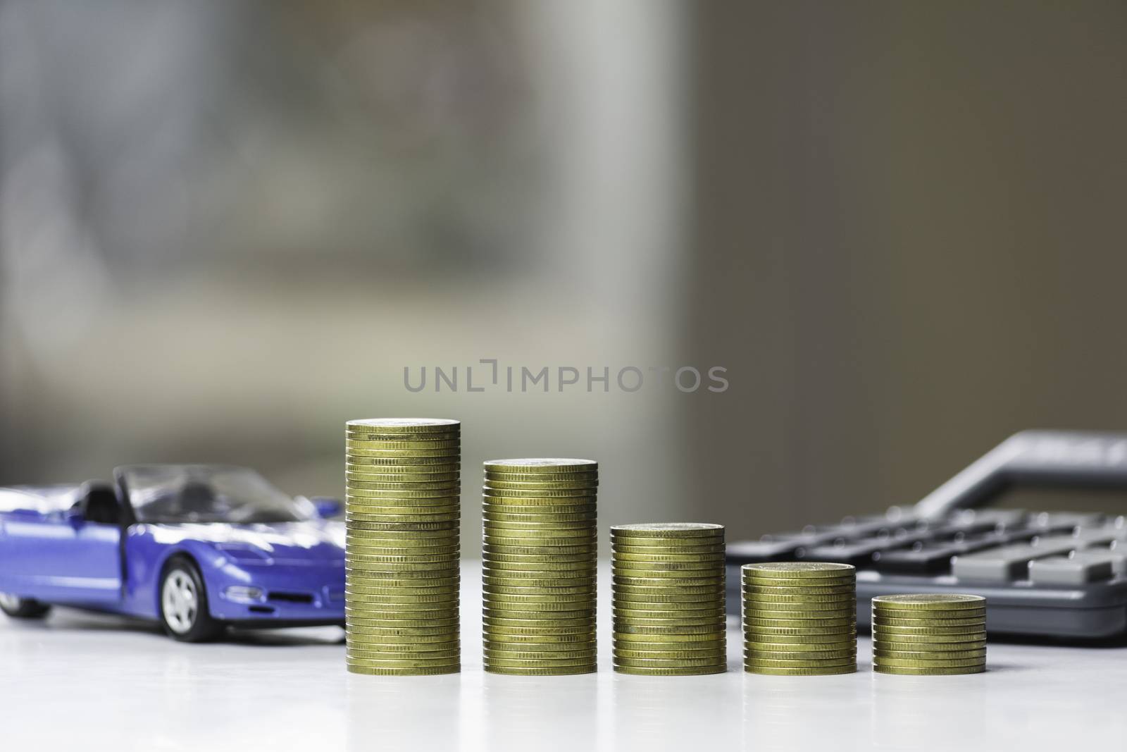 Car insurance and car service. Line graph with stack of coins and toy car, business and financial concept.