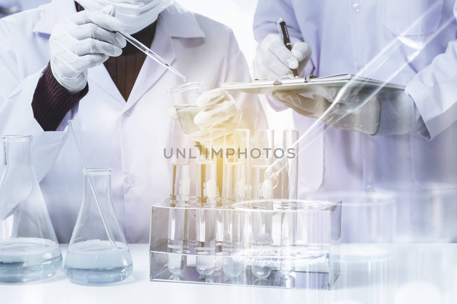 Researcher with glass laboratory chemical test tubes with liquid by kirisa99