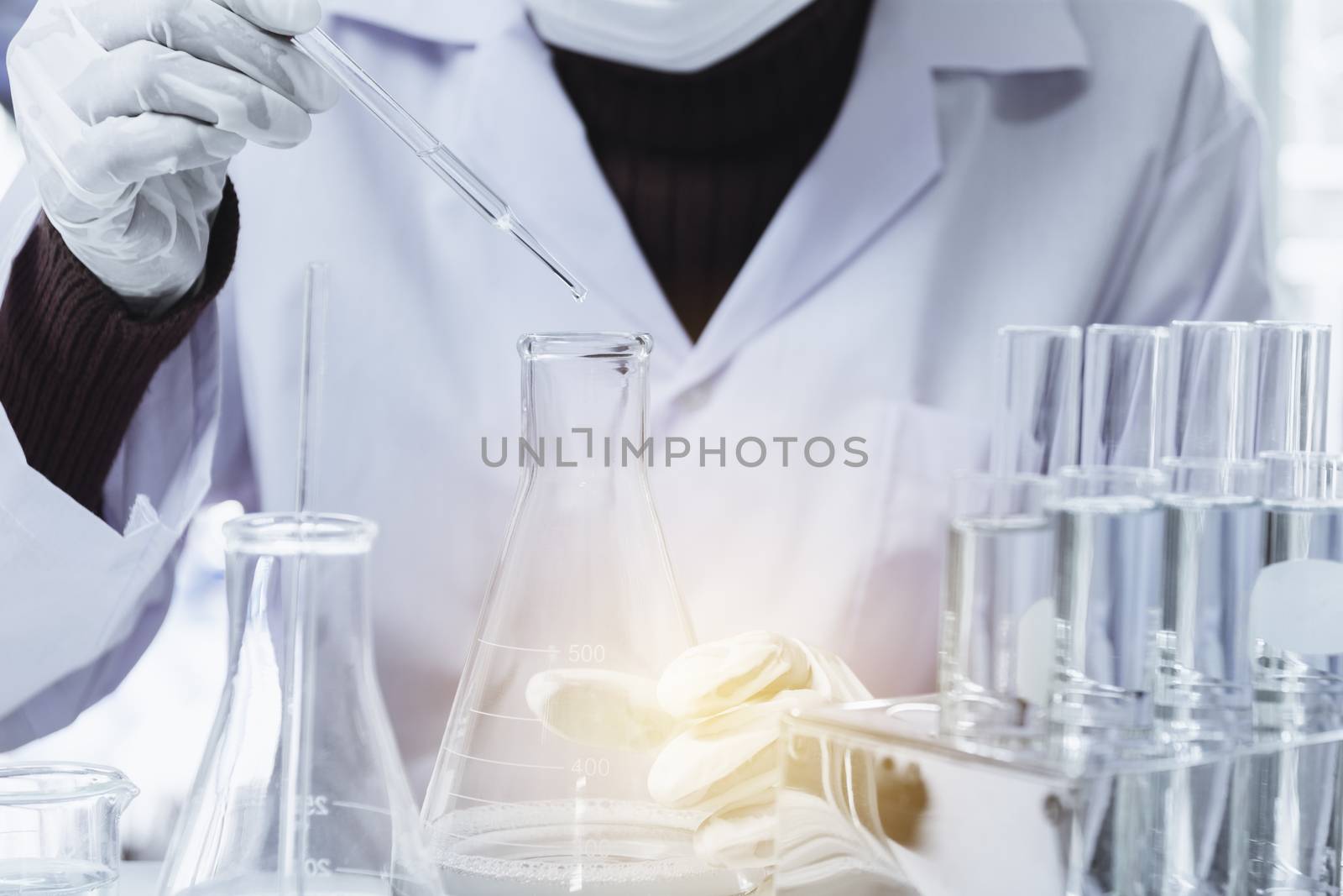 Researcher with glass laboratory chemical test tubes with liquid by kirisa99