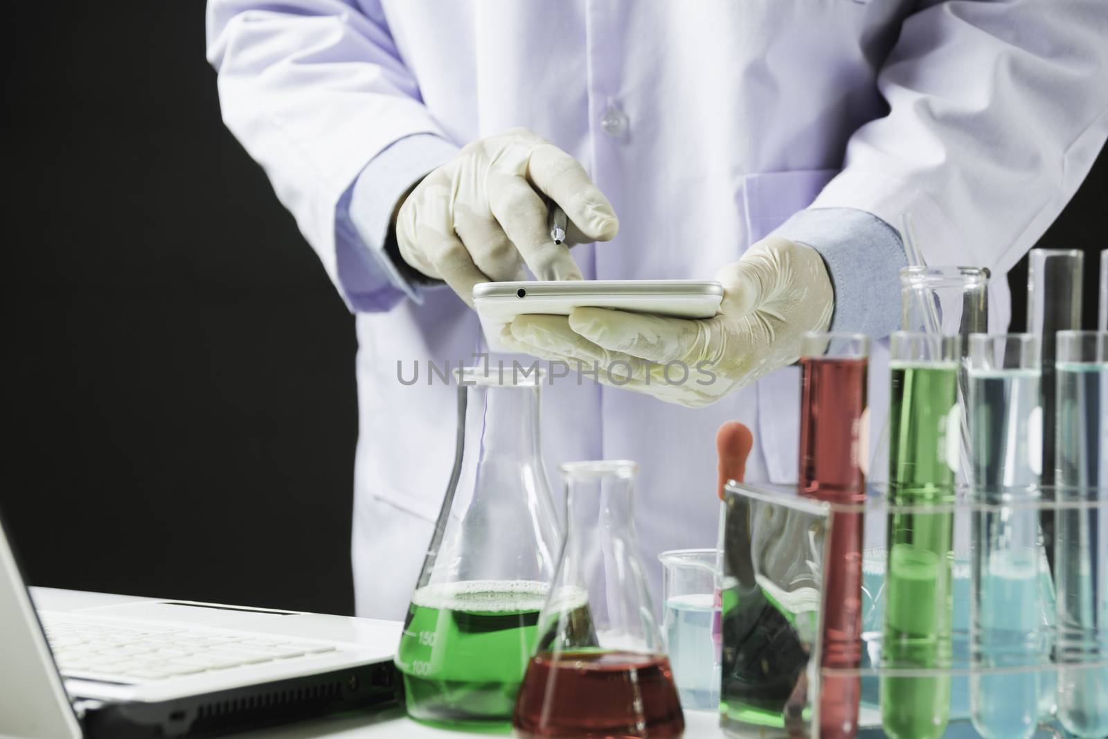 Researcher with glass laboratory chemical test tubes with liquid for analytical , medical, pharmaceutical and scientific research concept.