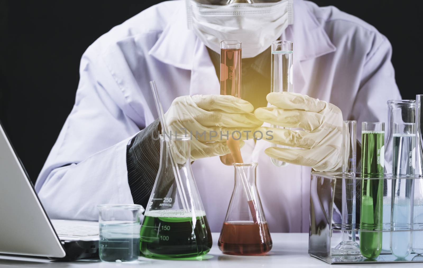 Researcher with glass laboratory chemical test tubes with liquid for analytical , medical, pharmaceutical and scientific research concept.