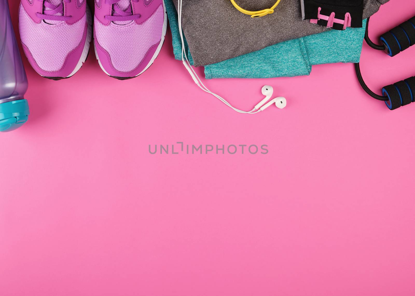 pink women's sneakers, a bottle of water, gloves and a jump rope by ndanko