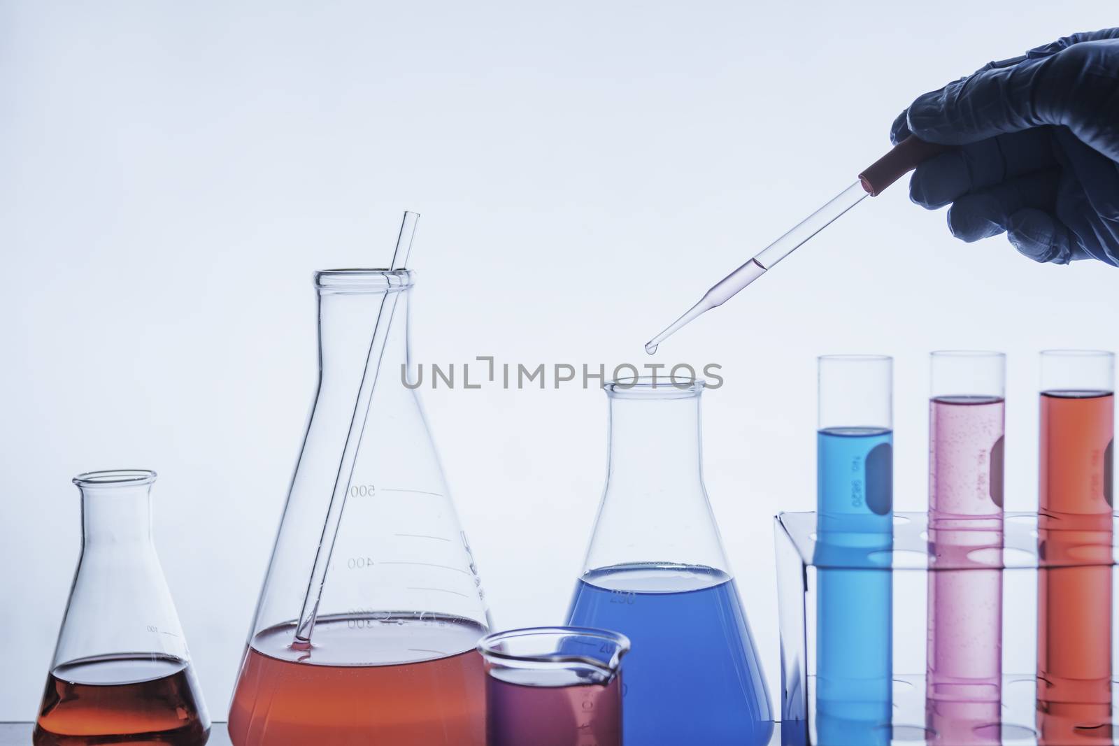 Researcher with glass laboratory chemical test tubes with liquid for analytical , medical, pharmaceutical and scientific research concept.