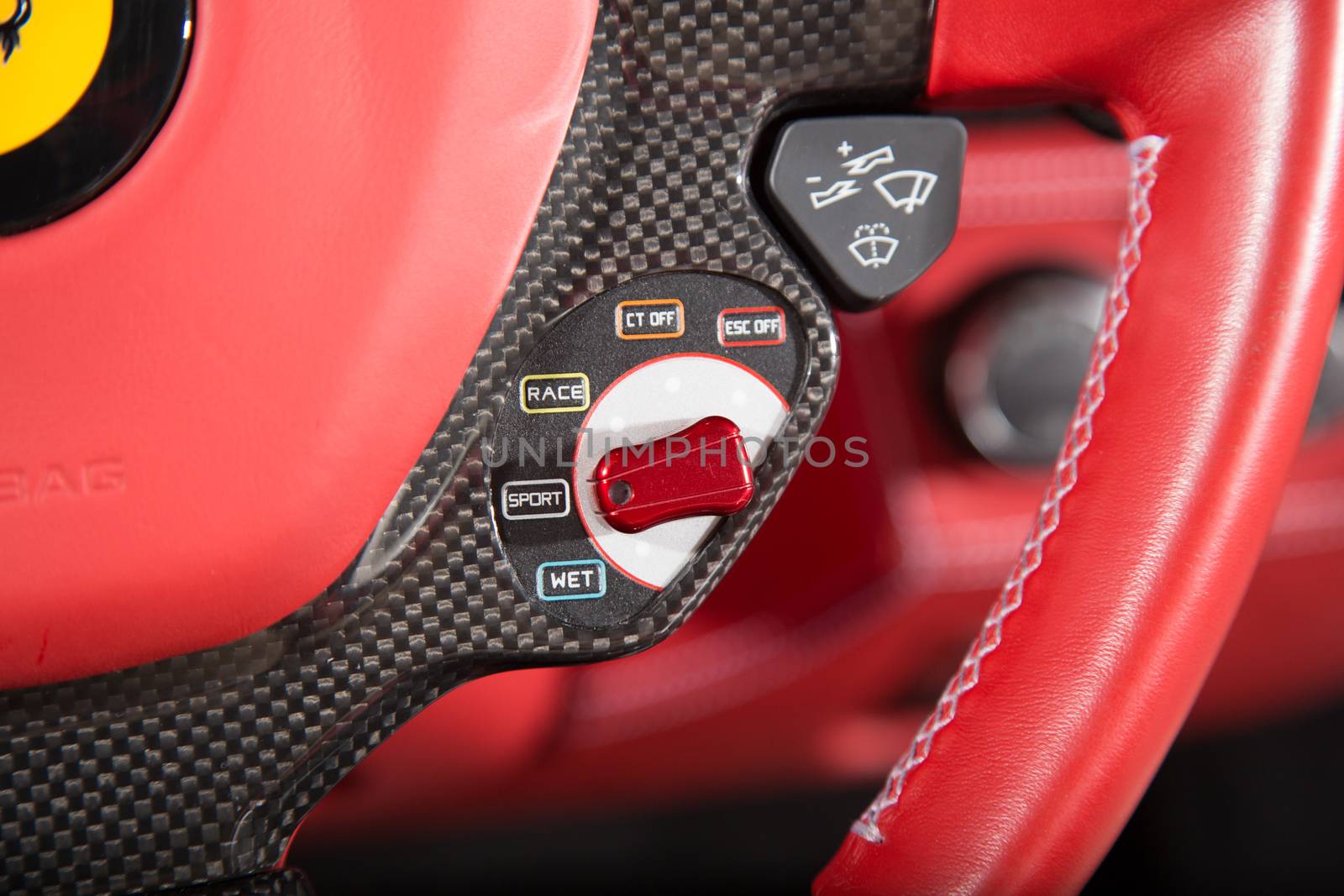 Close up of control buttons on red leather steering wheel