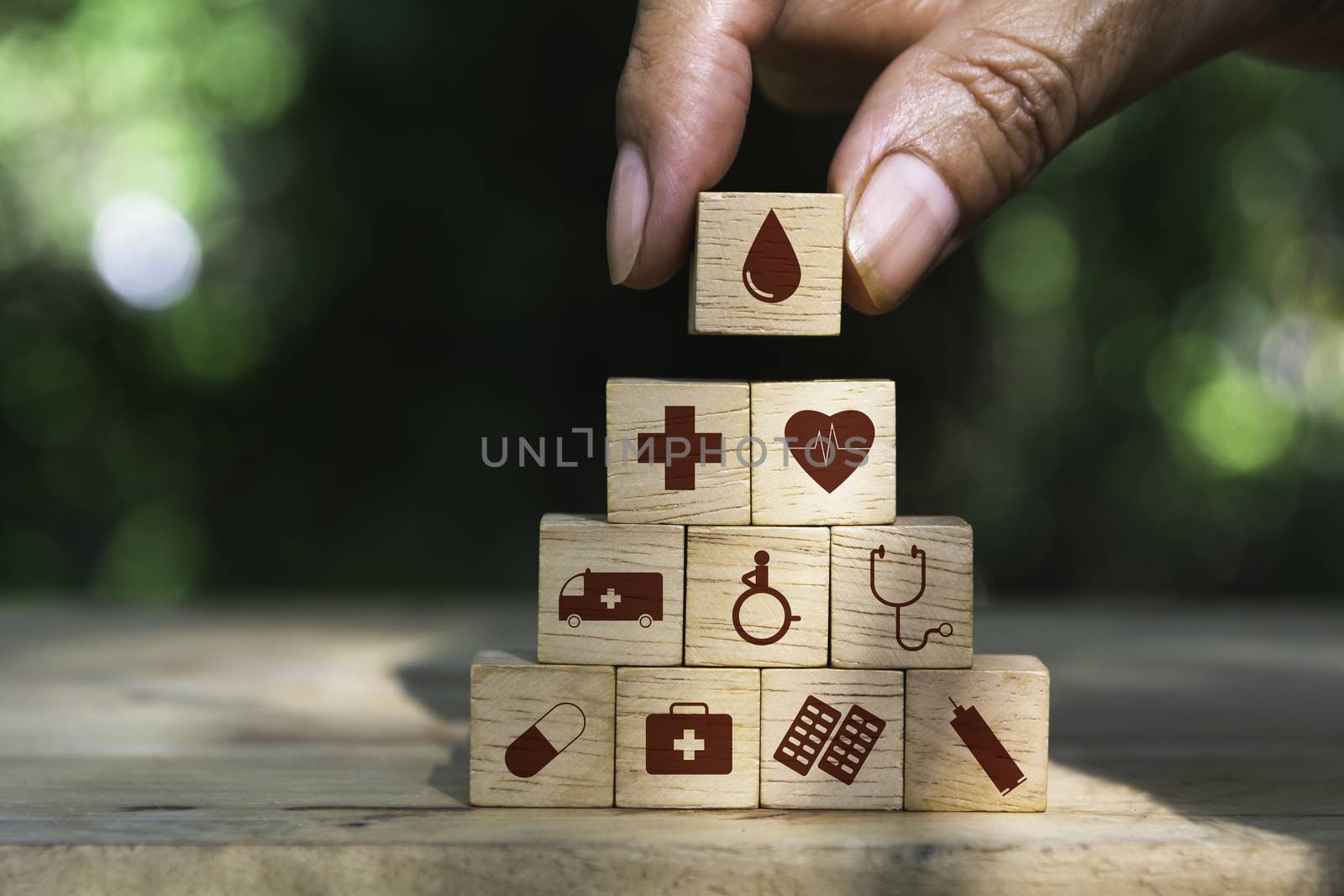 Hand holding cube dice health and medical symbols with copy space.  Healthy and medical concept.
