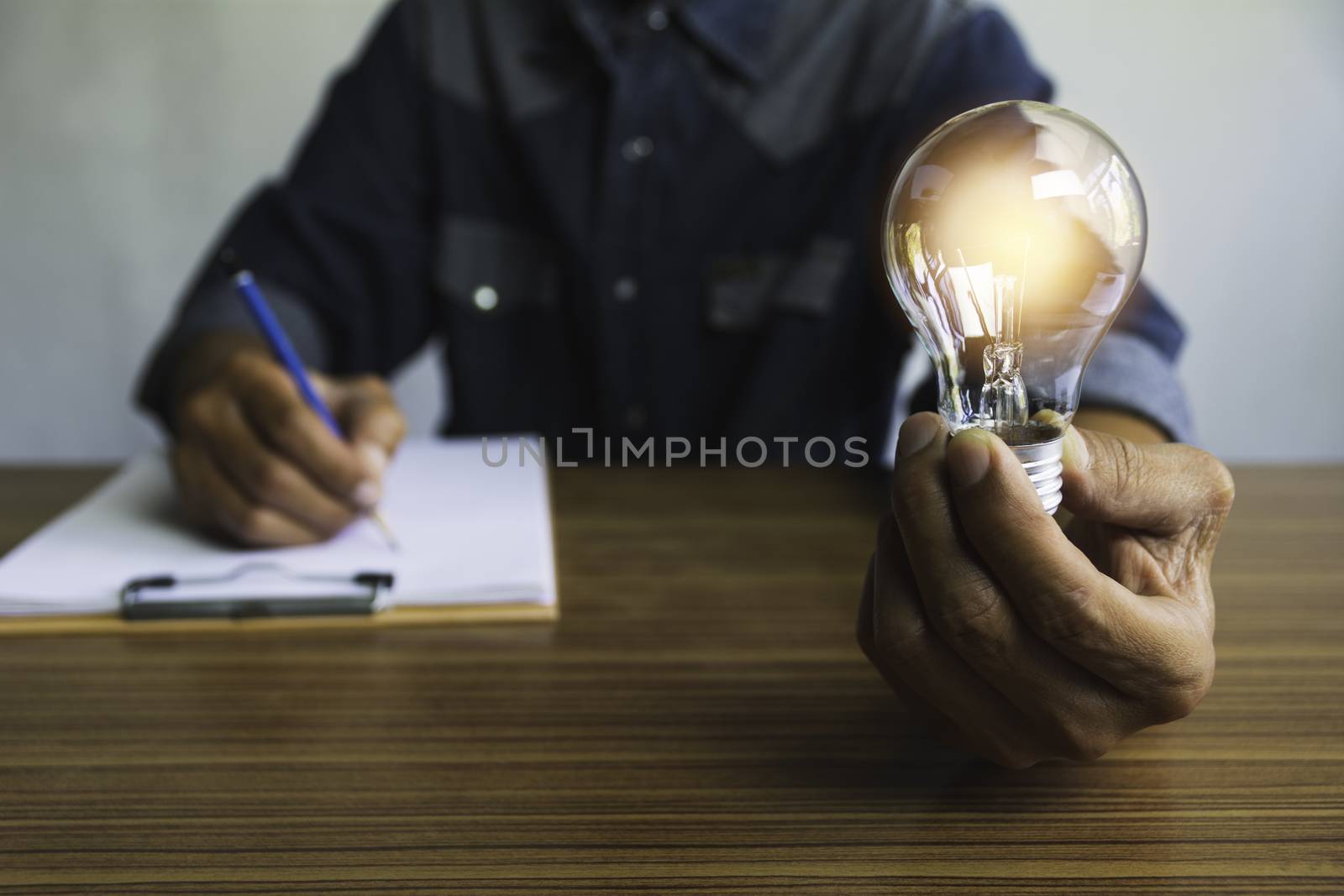 Hand of male holding a light bulb and copy space for accounting, ideas and creative concept.