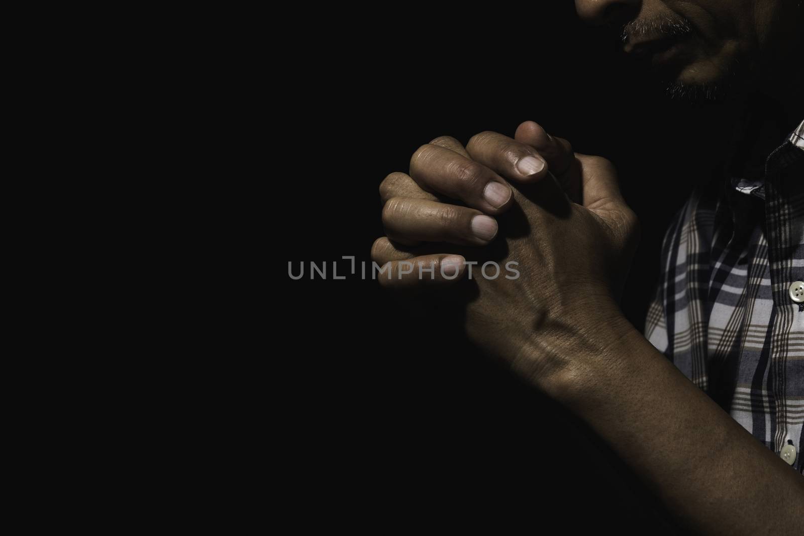 Hand of man while praying for religion. Concept peace and life. by kirisa99