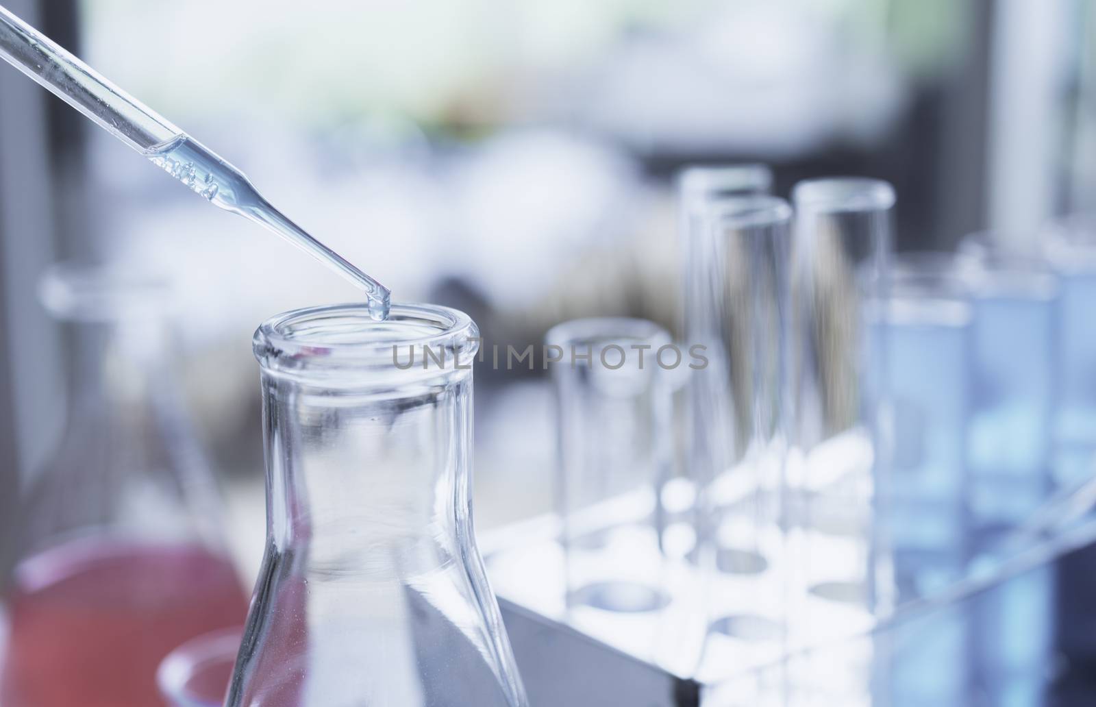 Researcher with glass laboratory chemical test tubes with liquid for analytical , medical, pharmaceutical and scientific research concept.