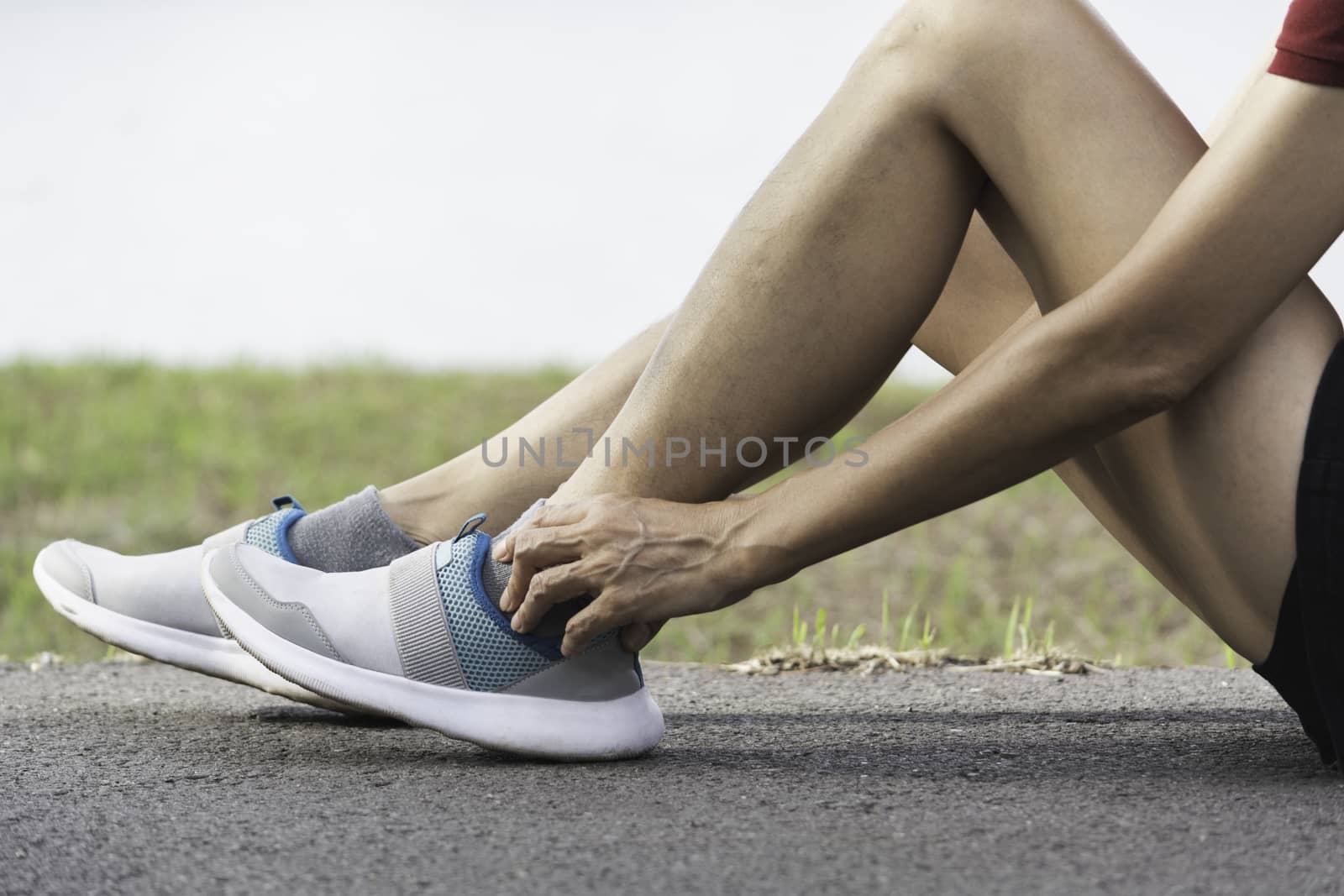 The female clings to a bad leg. The pain in her leg. Health and painful concept.