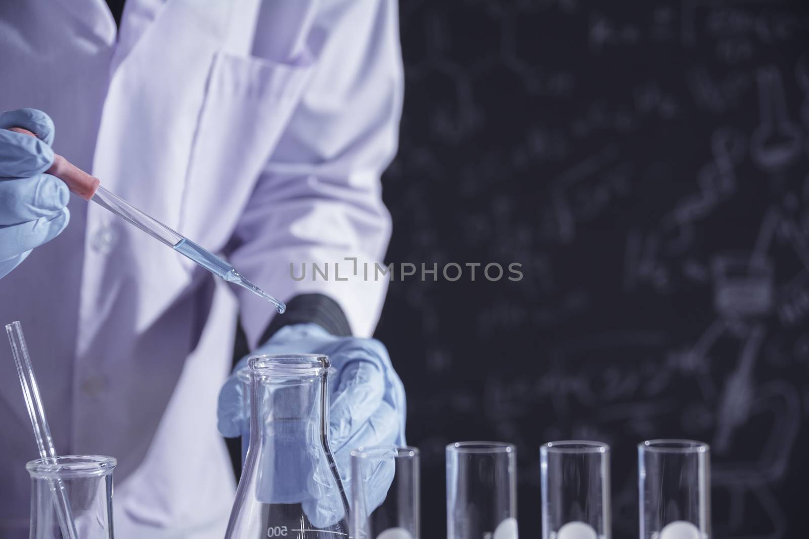 Researcher with glass laboratory chemical test tubes with liquid for analytical , medical, pharmaceutical and scientific research concept.