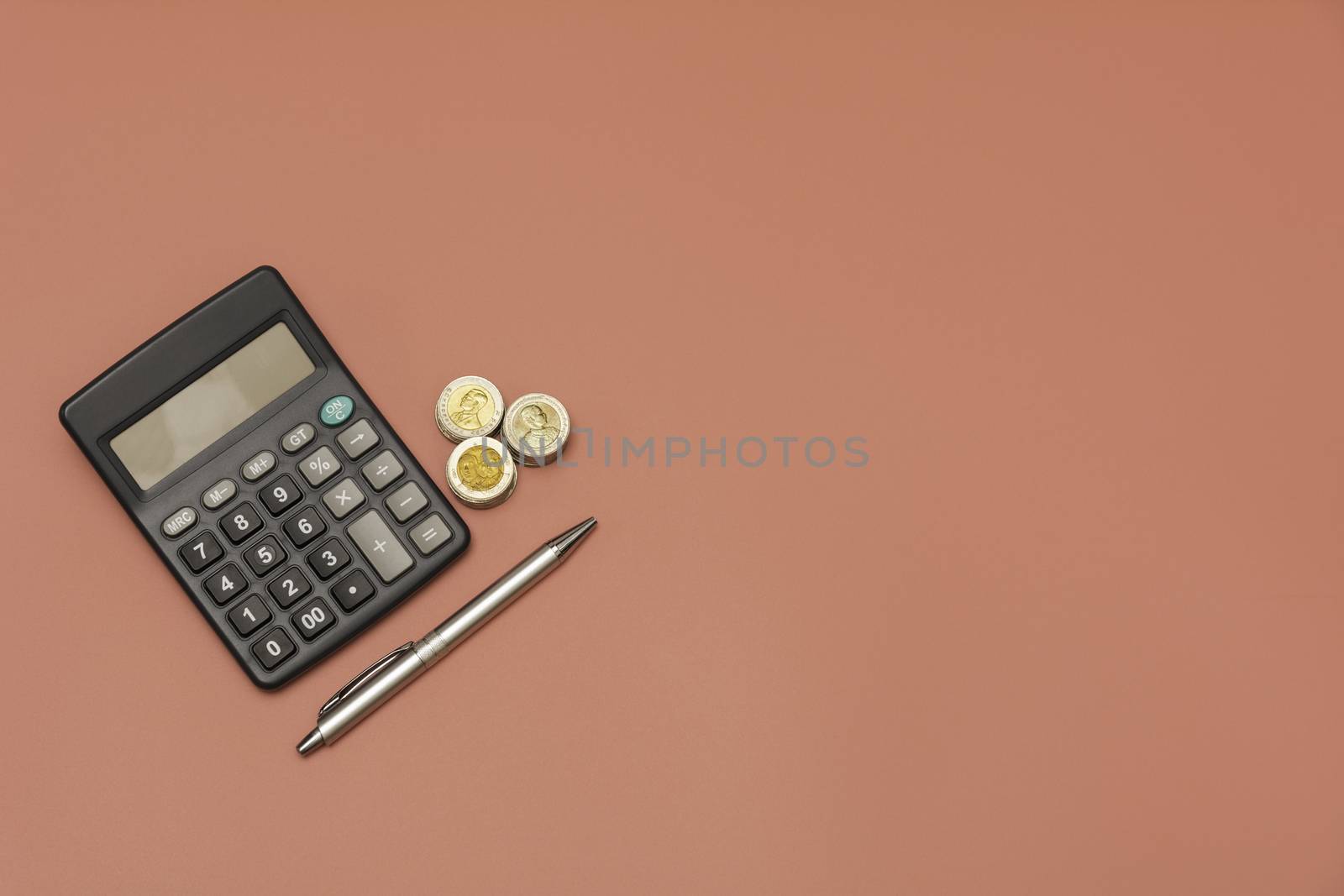 Stack of coin and calculator with copy space. Accounting and business concept.