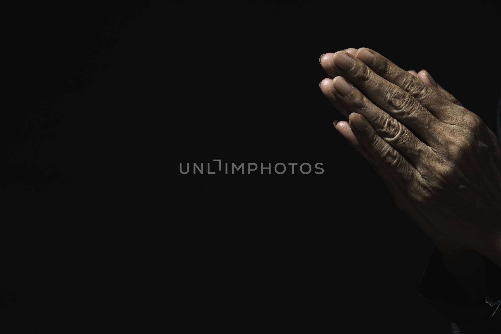 Hand of man while praying for religion. Concept peace and life. by kirisa99