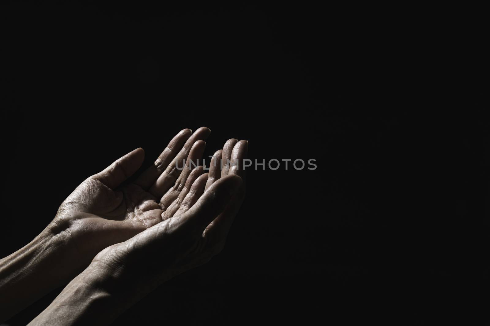 Hand of man while praying for religion. Concept peace and life. by kirisa99