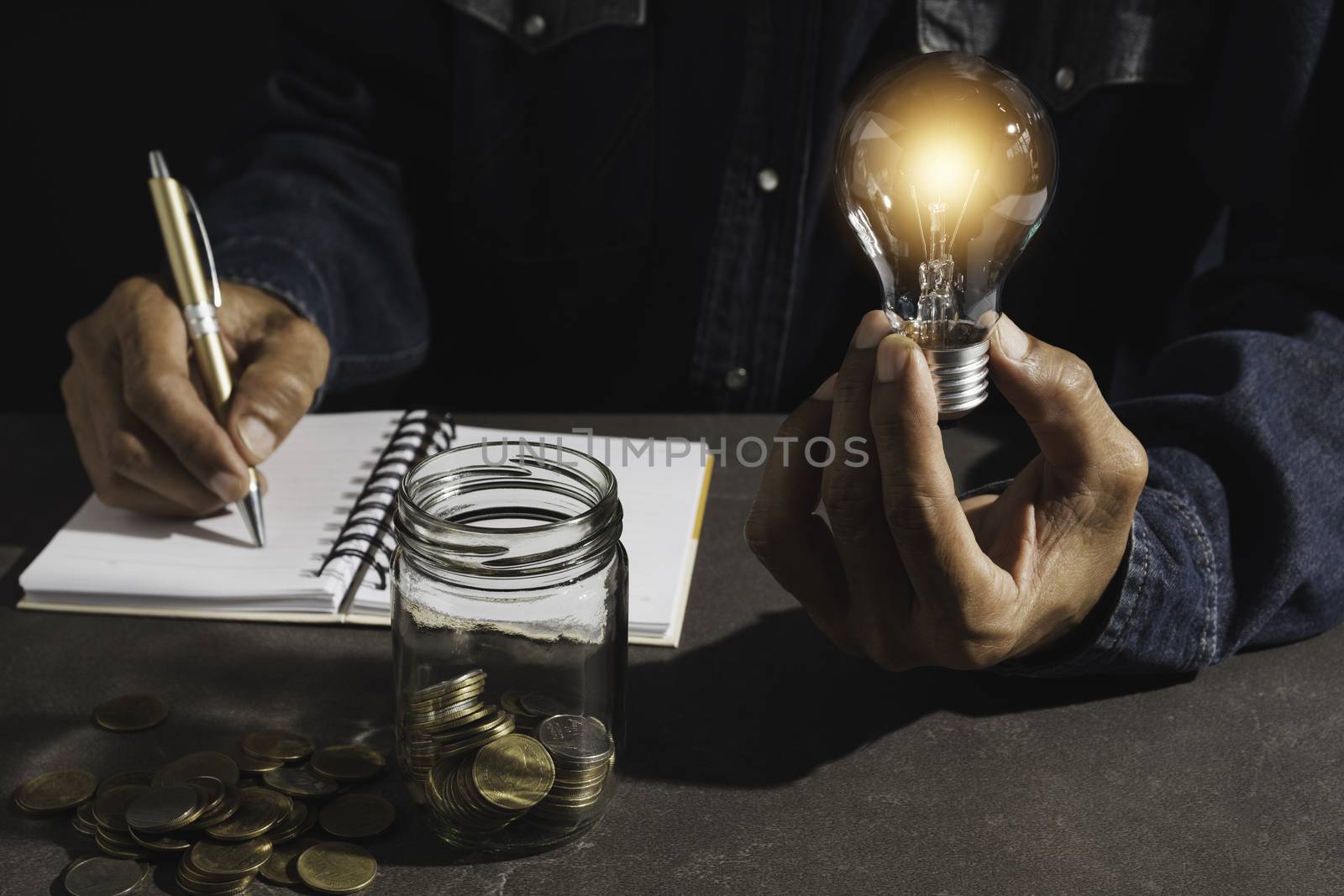 Hand of male holding a light bulb and copy space for accounting, ideas and creative concept.