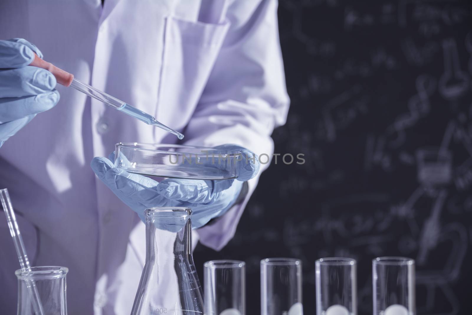 Researcher with glass laboratory chemical test tubes with liquid for analytical , medical, pharmaceutical and scientific research concept.