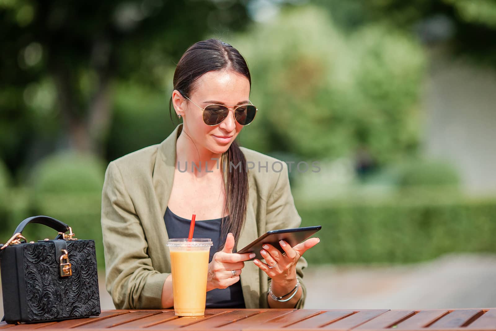 Young woman eating take away noodles on the street by travnikovstudio