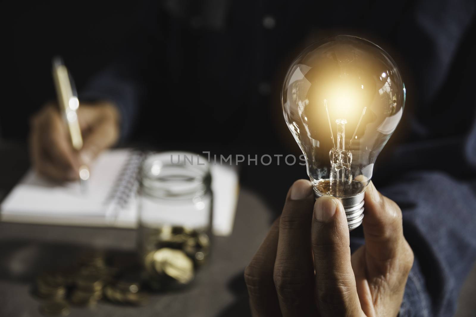 Hand of male holding a light bulb and copy space for accounting, by kirisa99