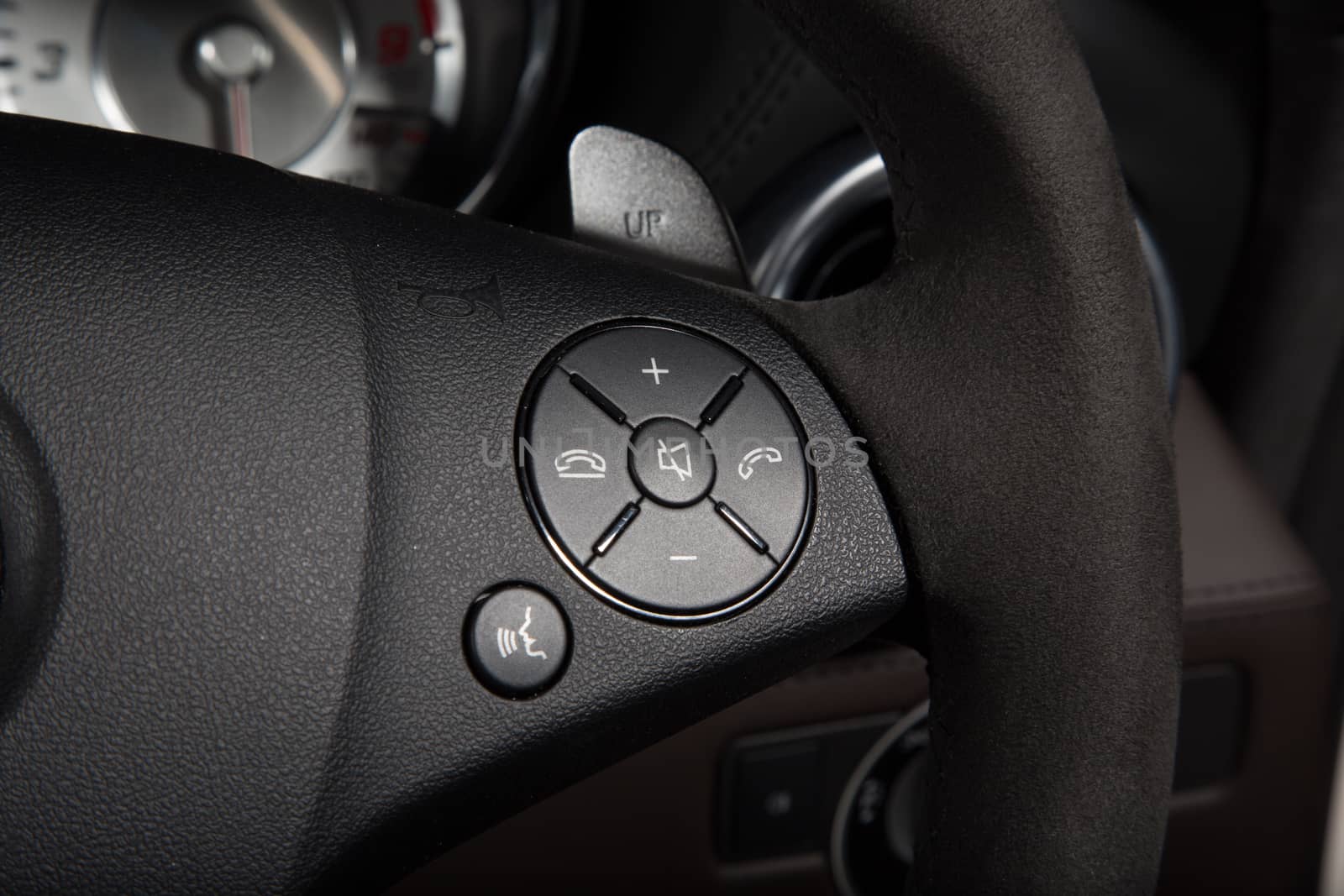 Close up of control buttons on black steering wheel by camerarules