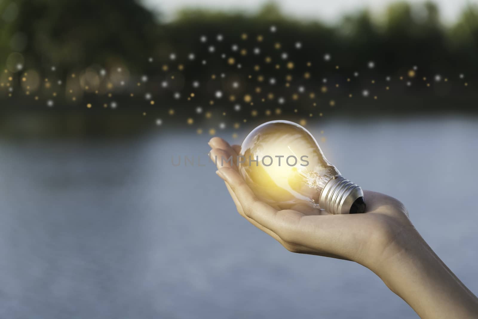 Innovation and energy concept of hand hold a light bulb and copy by kirisa99