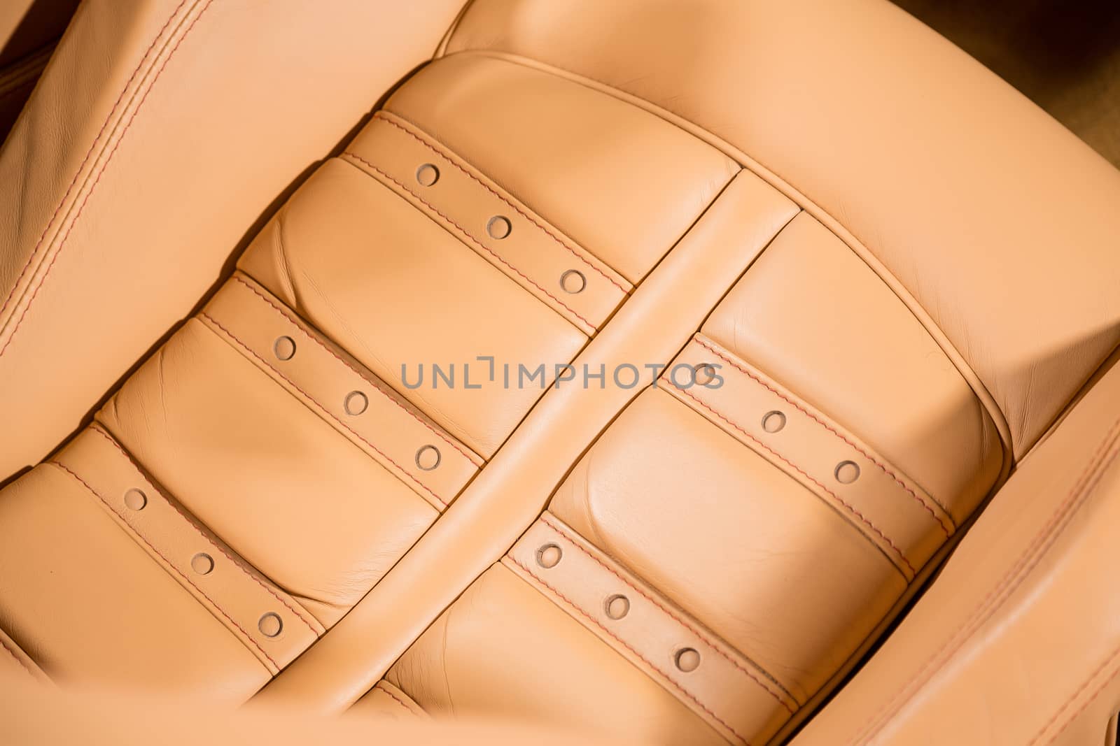 Close up of leather car seat in brown by camerarules