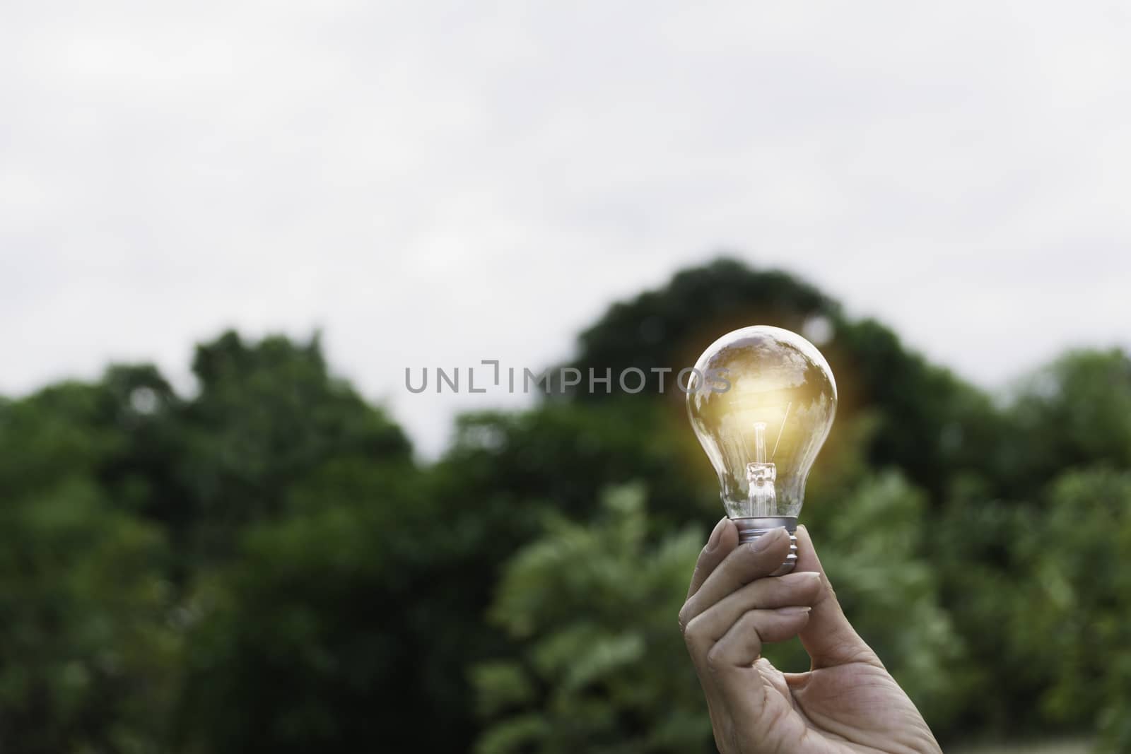 Innovation and energy concept of hand hold a light bulb and copy by kirisa99
