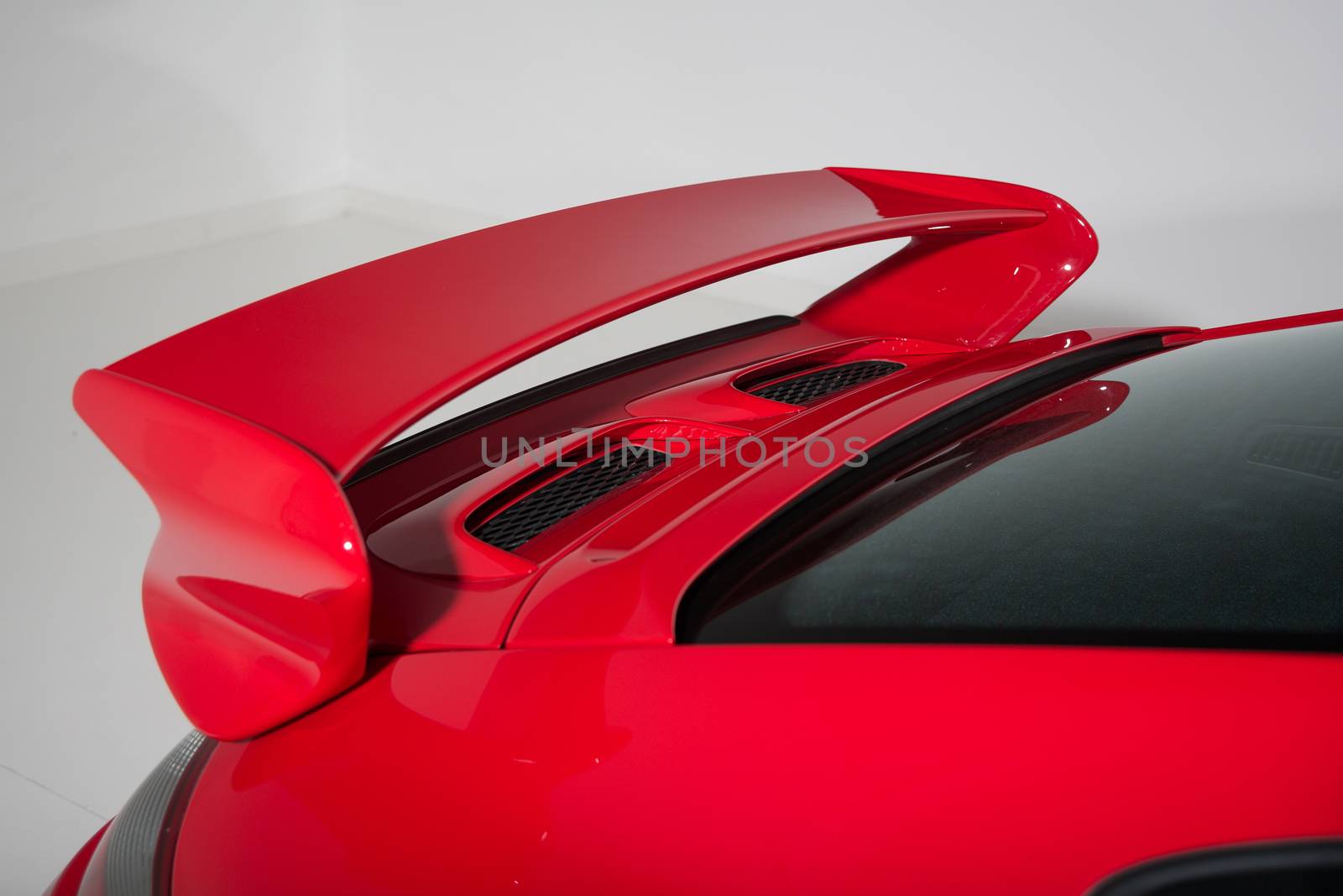 Close up of rear spoiler on sports car by camerarules