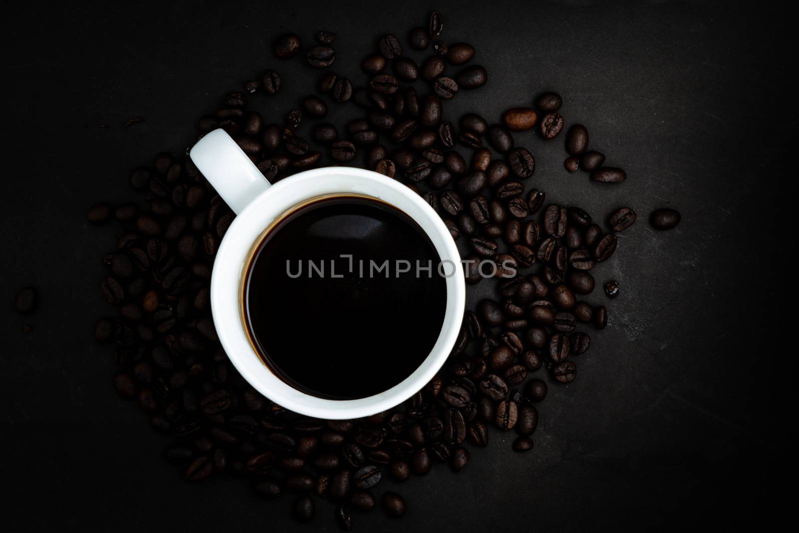 The Top view of Instant coffee in cup on dark background with beans and space for putting text