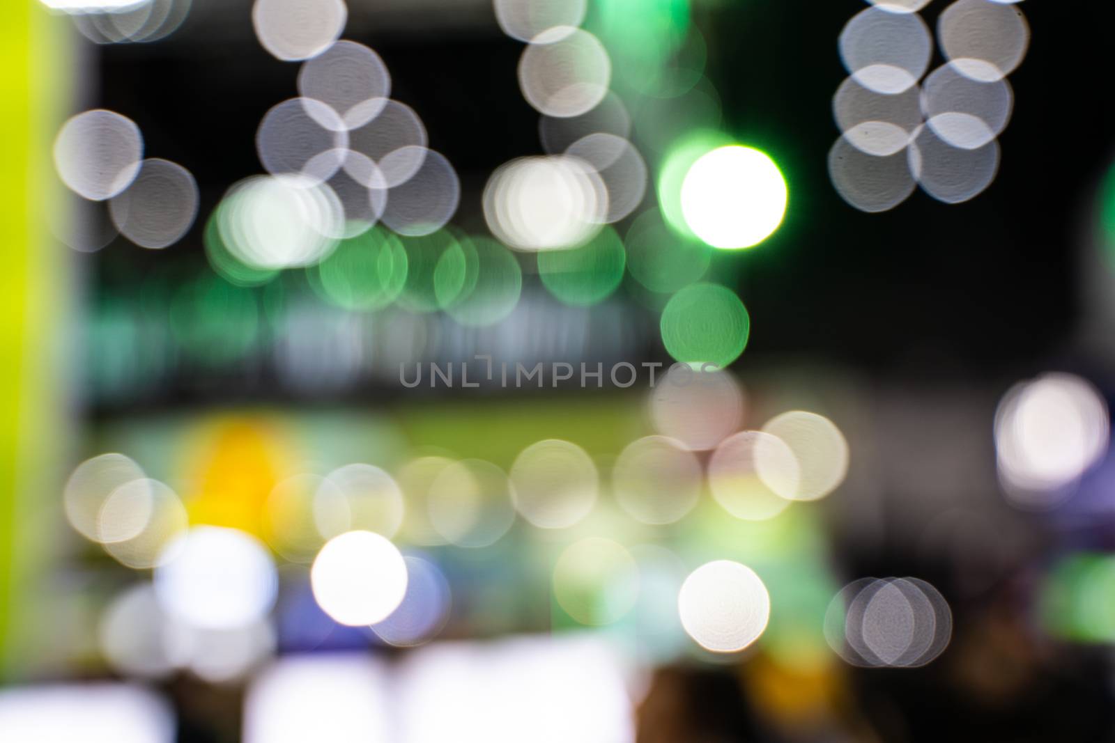 The colorful bokeh lights from vehicles on the road with traffic in dark night , in vintage film color style