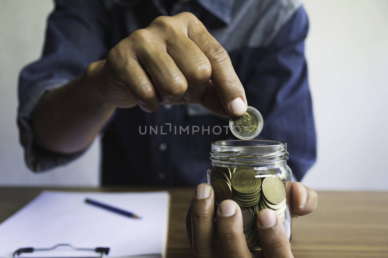 Hand drop a coin in glass jar for business. Financial and accoun by kirisa99