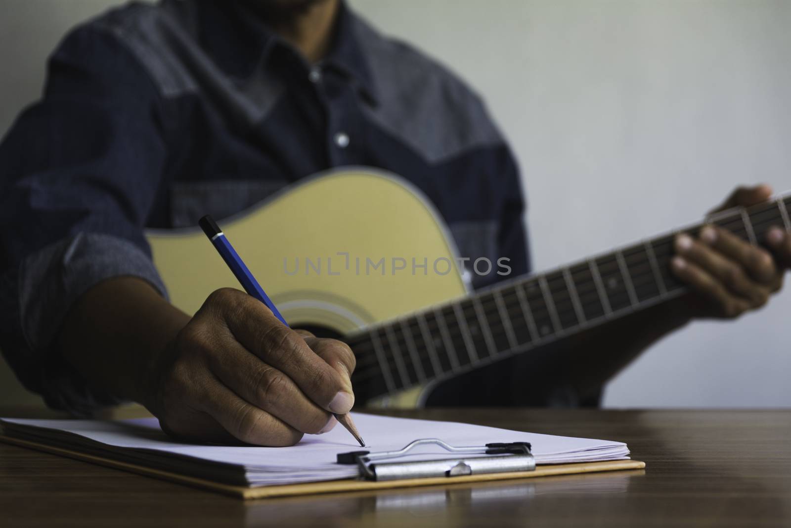 Composer holding pencil and writing lyrics in paper. Musician pl by kirisa99