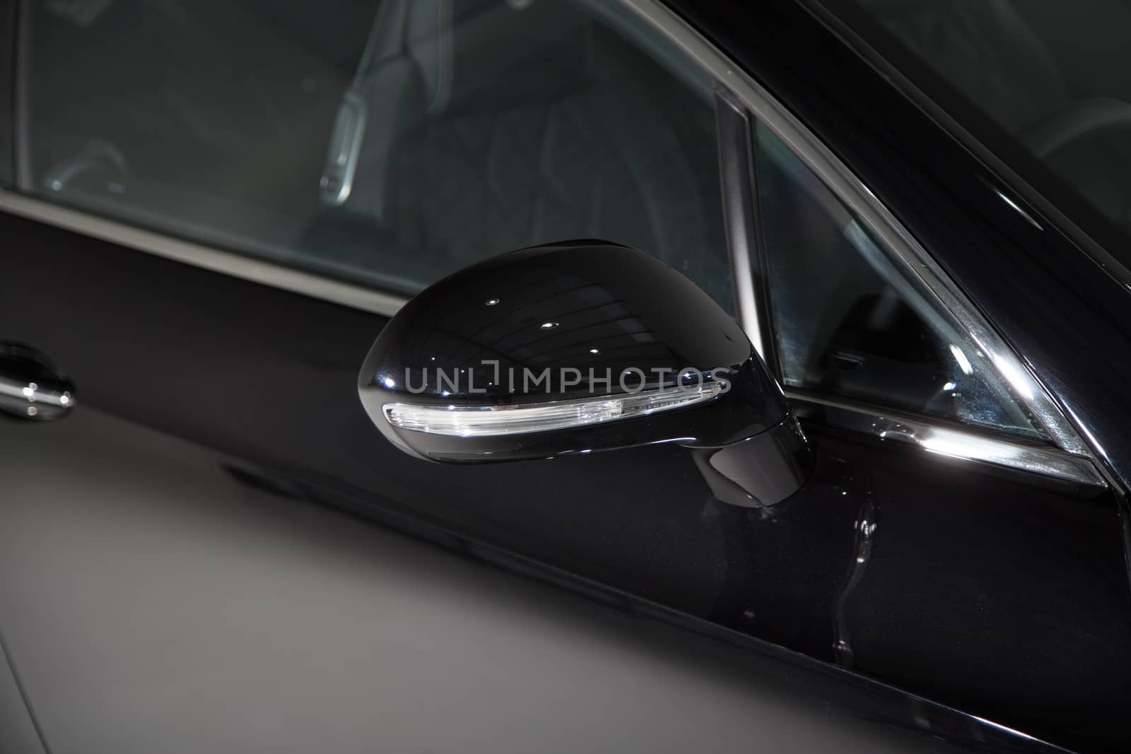 Close up of mirror on black luxury car