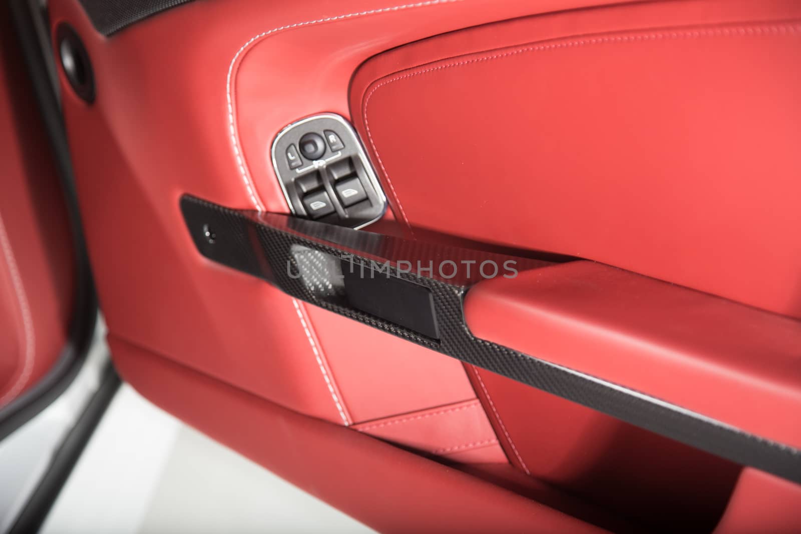 Detail of car door panel in red leather trim