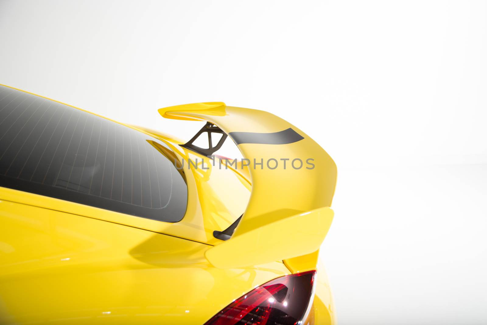 Rear spoiler on yellow sports car by camerarules